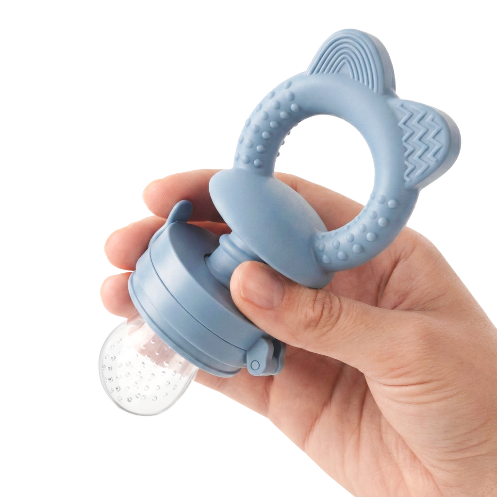 Blue MAMAMEEPA baby fruit feeder held in hand showing teething ring and silicone pouch